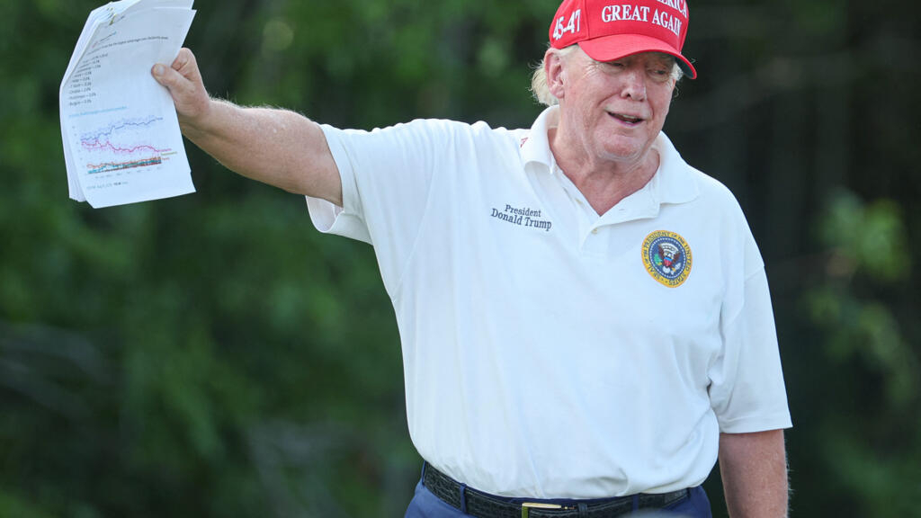 11 de agosto de 2023, Bedminster, Nueva Jersey, Estados Unidos. El expresidente Donald Trump sostiene papeles que muestran las proyecciones de las encuestas para las primarias de candidatos republicanos de 2024 durante la primera ronda del torneo de golf LIV Golf Bedminster en el Trump National Bedminster. C